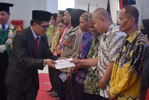 Karo AAKK Drs. H. Rijalul Faqih, M.Si. saat memberikan bantuan kepada Irwansyah, Petugas Kebersihan FUH UIN Antasari (Foto-Humas-Hadi Rustami)