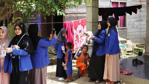 Para mahasisiwi saat bermain dengan anak-anak Desa Haruyan Dayak (Foto:Humas/Achmad Maghfur)