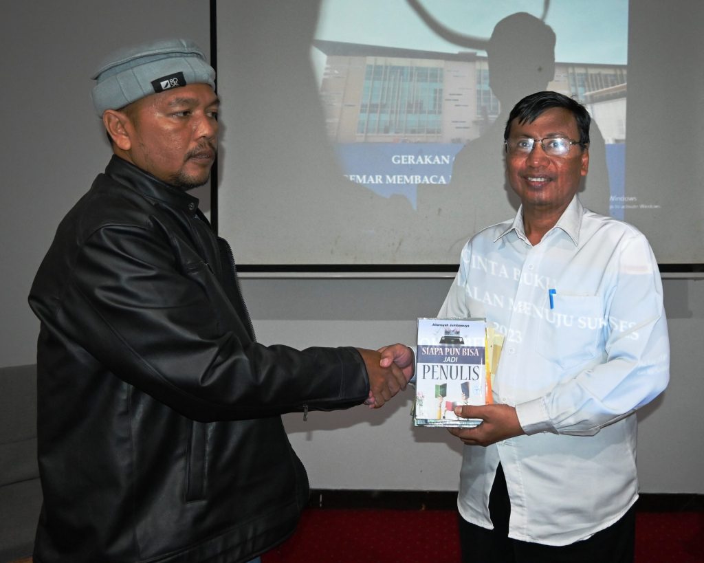 Aliansyah Jumbawuya (kiri) saat menyerahkan banyak karyanya untuk menjadi koleksi Perpustakaan UIN Antasari (Foto:Humas/Achmad Magfur)