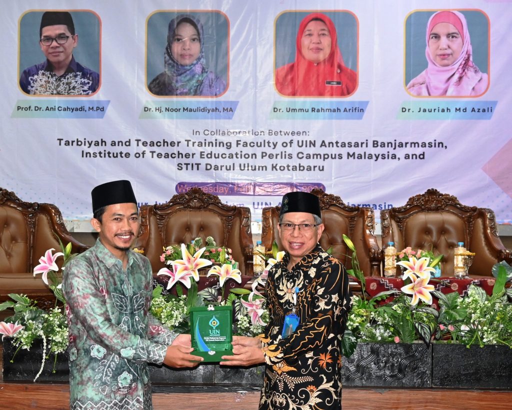 Ketua STIT Darul Ulum Kotabaru Dr, Muhammad Zaim, M.Pd.I. saat menerima kenang-kenagan dari Dekan FTK UIN Antasari Dr. H. Hamdan, M.Pd. (Foto:Humas/Jamal Ripani)