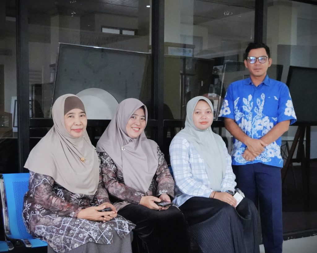 Hj. Nidawati, M.Ag. (kiri) saat berfoto bersama para petugas Perpustakaan UIN Antasari (Foto:Humas/Rahmi Hartati)